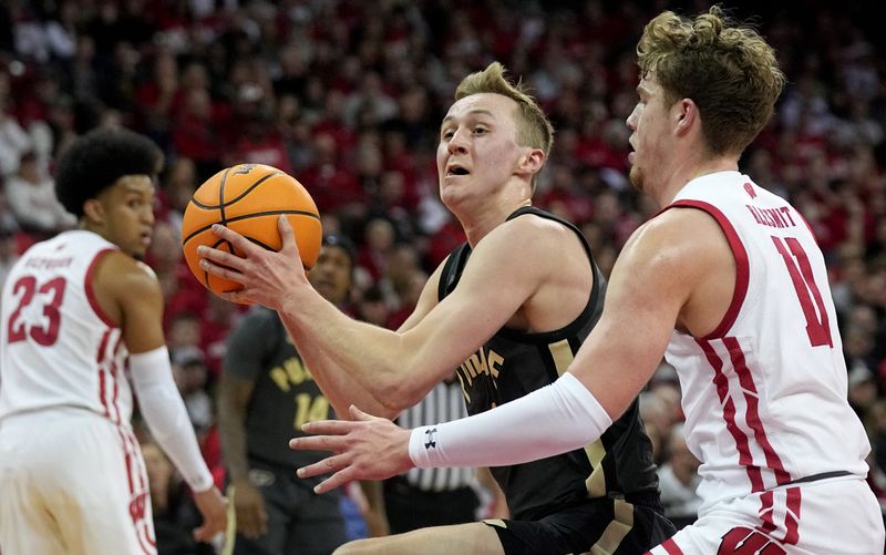 Mar. 2, 2023; Milwaukee, Wisconsin, USA; Purdue Boilermakers guard Fletcher Loyer (2) drives on Wisconsin Badgers guard Max Klesmit (11) during the first half of their game at Kohl Center. Mandatory Credit: Mark Hoffman-USA TODAY Sports