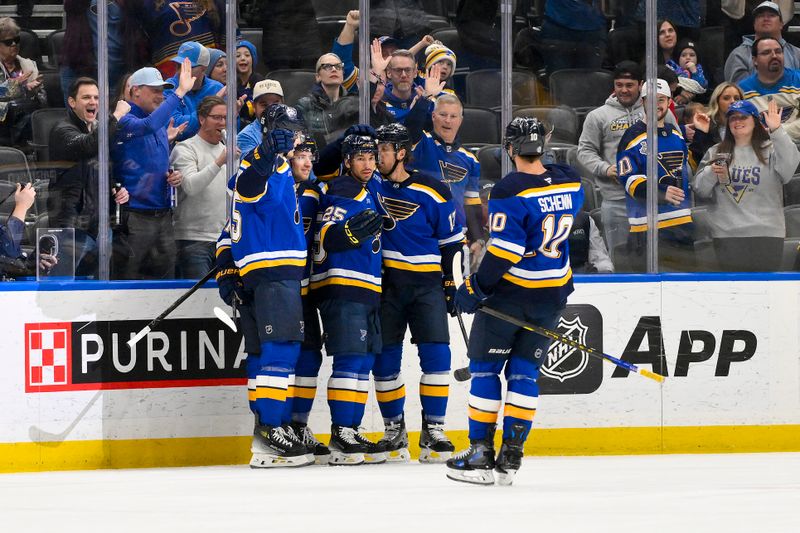 Feb 25, 2025; St. Louis, Missouri, USA;  St. Louis Blues center Jordan Kyrou (25) is congratulated by teammates after scoring against the Seattle Kraken during the first period at Enterprise Center. Mandatory Credit: Jeff Curry-Imagn Images