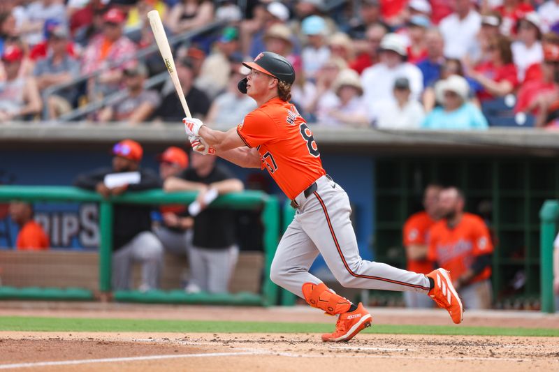 Mar 5, 2024; Clearwater, Florida, USA;  Baltimore Orioles shortstop Jackson Holiday (87) hits a triple against the Philadelphia Phillies in the third inning at BayCare Ballpark. Mandatory Credit: Nathan Ray Seebeck-USA TODAY Sports