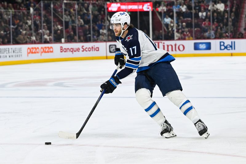 Oct 28, 2023; Montreal, Quebec, CAN; Winnipeg Jets center Adam Lowry (17) skates with the puck on a penalty shot against the Montreal Canadiens during the first period at Bell Centre. Mandatory Credit: David Kirouac-USA TODAY Sports