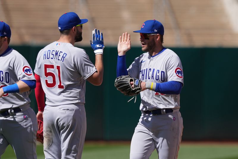 Apr 19, 2023; Oakland, California, USA; Chicago Cubs first baseman Eric Hosmer (51) and right fielder Patrick Wisdom (right) celebrate after defeating the Oakland Athletics at Oakland-Alameda County Coliseum. Mandatory Credit: Darren Yamashita-USA TODAY Sports