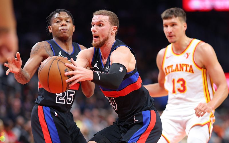 ATLANTA, GEORGIA - APRIL 03:  Malachi Flynn #14 of the Detroit Pistons steals this inbounds pass to Bogdan Bogdanovic #13 of the Atlanta Hawks during the fourth quarter at State Farm Arena on April 03, 2024 in Atlanta, Georgia.  NOTE TO USER: User expressly acknowledges and agrees that, by downloading and/or using this photograph, user is consenting to the terms and conditions of the Getty Images License Agreement.  (Photo by Kevin C. Cox/Getty Images)