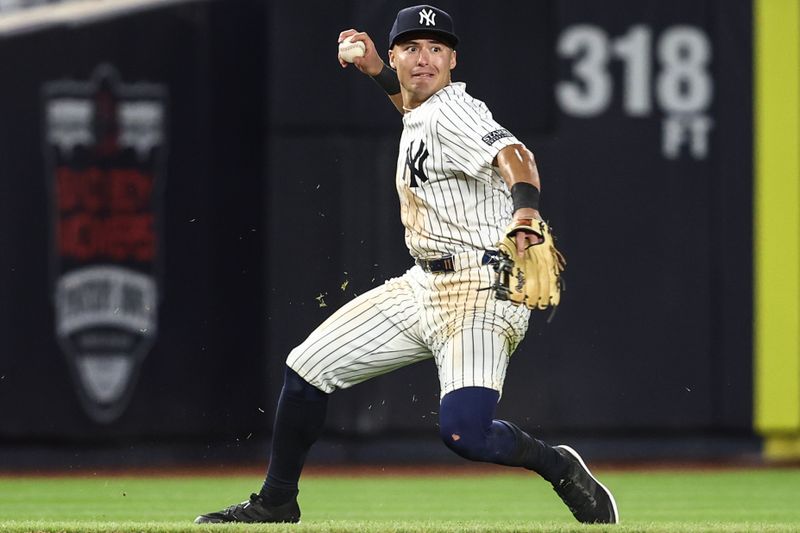 Apr 6, 2024; Bronx, New York, USA; New York Yankees shortstop Anthony Volpe (11) throws to second base in the ninth inning against the Toronto Blue Jays at Yankee Stadium. Mandatory Credit: Wendell Cruz-USA TODAY Sports