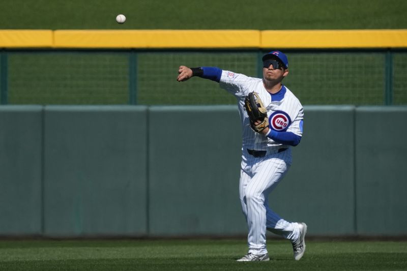 Feb 20, 2026; Mesa, Arizona, USA; Chicago Cubs right fielder Seiya Suzuki (27) fields the ball against the Chicago White Sox in the second inning at Sloan Park. Mandatory Credit: Rick Scuteri-Imagn Images