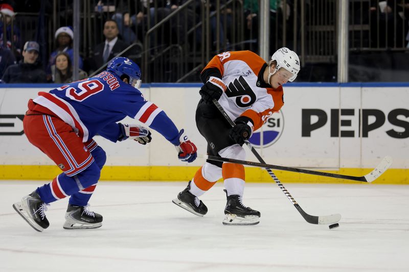 Dec 20, 2025; New York, New York, USA; Philadelphia Flyers right wing Matvei Michkov (39) plays the puck against New York Rangers defenseman Matthew Robertson (29) during the first period at Madison Square Garden. Mandatory Credit: Brad Penner-Imagn Images