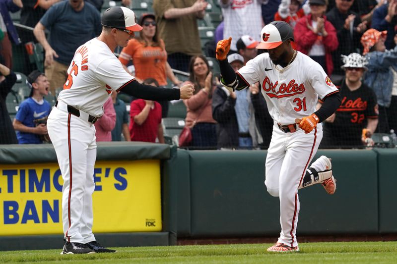 Apr 17, 2024; Baltimore, Maryland, USA; Baltimore Orioles outfielder Cedric Mullins (31) greeted by coach Tony Mansolino (36) following his game winning two run home run in the ninth inning against the Minnesota Twins at Oriole Park at Camden Yards. Mandatory Credit: Mitch Stringer-USA TODAY Sports