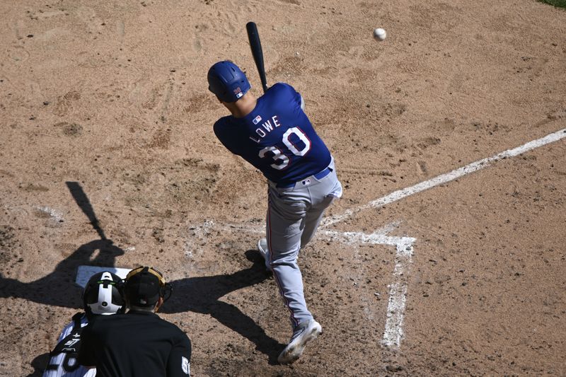 Aug 29, 2024; Chicago, Illinois, USA;  Texas Rangers first base Nathaniel Lowe (30) hits a double against the Chicago White Sox during the seventh inning at Guaranteed Rate Field. Mandatory Credit: Matt Marton-USA TODAY Sports