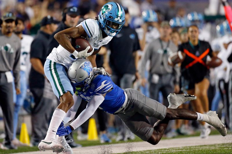 Oct 13, 2023; Memphis, Tennessee, USA; Tulane Green Wave wide receiver Chris Brazzell II (17) catches the ball as Memphis Tigers defensive back Malik Feaster (7) makes the tackle during the first half at Simmons Bank Liberty Stadium. Mandatory Credit: Petre Thomas-USA TODAY Sports