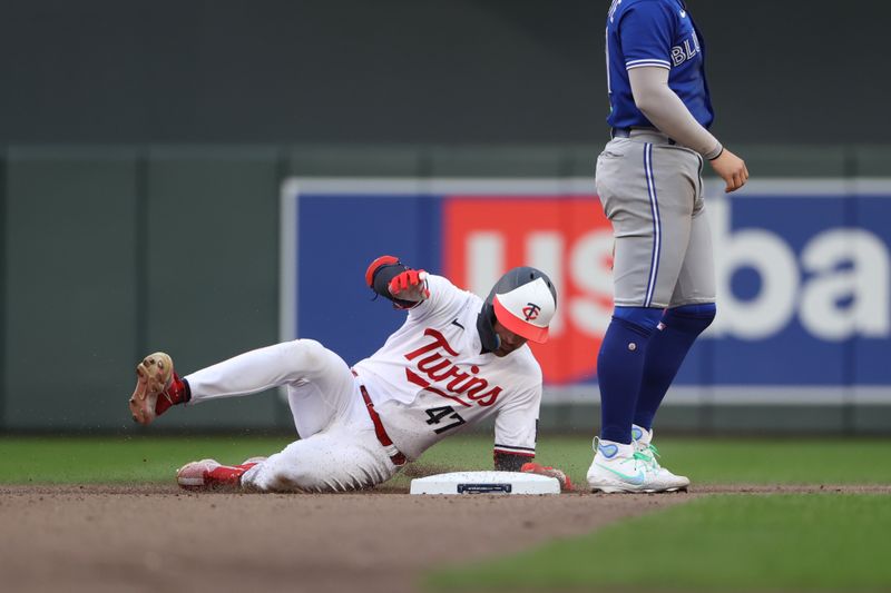 Oct 4, 2023; Minneapolis, Minnesota, USA; Minnesota Twins second baseman Edouard Julien (47) slides into second base in the seventh inning against the Toronto Blue Jays during game two of the Wildcard series for the 2023 MLB playoffs at Target Field. Mandatory Credit: Jesse Johnson-USA TODAY Sports