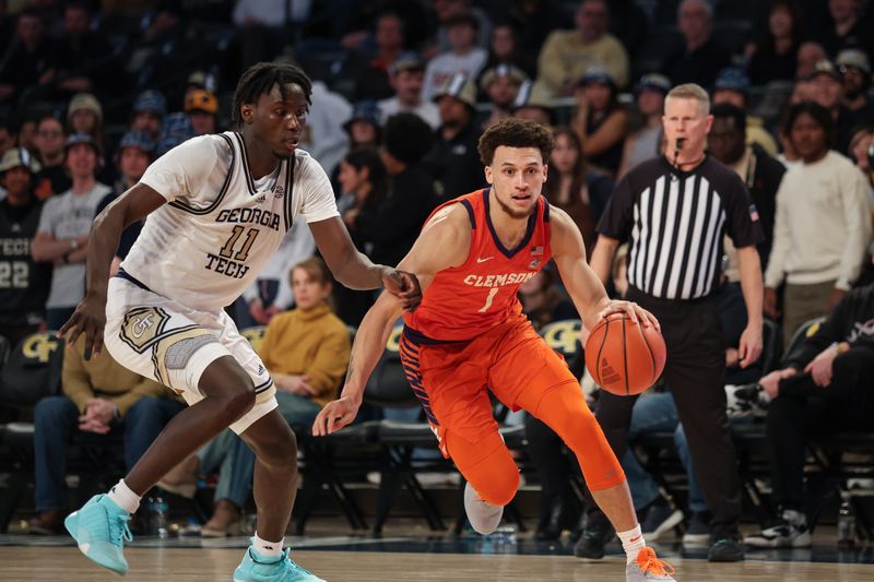 Jan 14, 2025; Atlanta, Georgia, USA; Clemson Tigers guard Chase Hunter (1) drives the ball past Georgia Tech Yellow Jackets forward Baye Ndongo (11) during the second half at McCamish Pavilion. Mandatory Credit: Jordan Godfree-Imagn Images