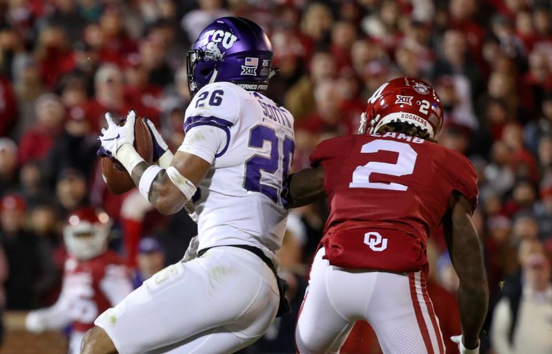 Nov 23, 2019; Norman, OK, USA; TCU Horned Frogs safety Vernon Scott (26) makes an interception in front of Oklahoma Sooners wide receiver CeeDee Lamb (2) during the fourth quarter at Gaylord Family - Oklahoma Memorial Stadium. Mandatory Credit: Kevin Jairaj-USA TODAY Sports