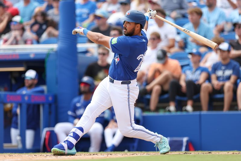 Mar 20, 2025; Dunedin, Florida, USA; Toronto Blue Jays outfielder Anthony Santander (25) hits a two rbi double against the Tampa Bay Rays in the fifth inning during spring training at TD Ballpark. Mandatory Credit: Nathan Ray Seebeck-Imagn Images