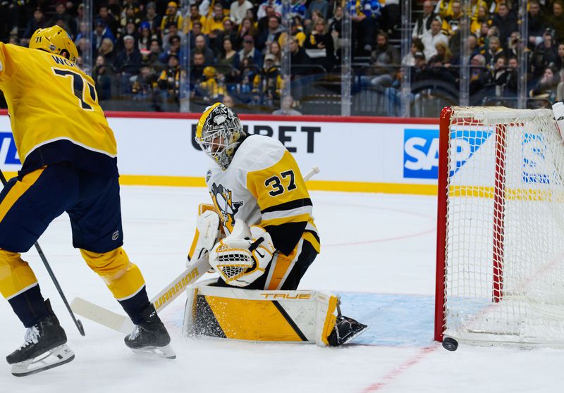 Nov 14, 2025; Stockholm, SWEDEN; Pittsburgh Penguins goaltender Arturs Silovs (37) makes a save against Nashville Predators right wing Matthew Wood (71) in a Global Series ice hockey game at Avicii Arena. Mandatory Credit: Per Haljestam-Imagn Images