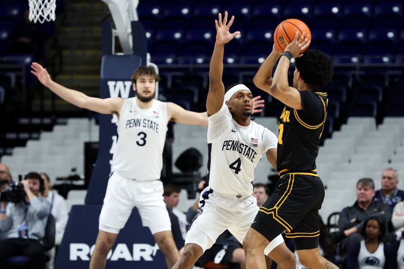 Feb 28, 2026; University Park, Pennsylvania, USA; Penn State Nittany Lions guard Kayden Mingo (4) defends as Iowa Hawkeyes guard Kael Combs (11) looks to pass the ball during the first half at Bryce Jordan Center. Mandatory Credit: Matthew O'Haren-Imagn Images