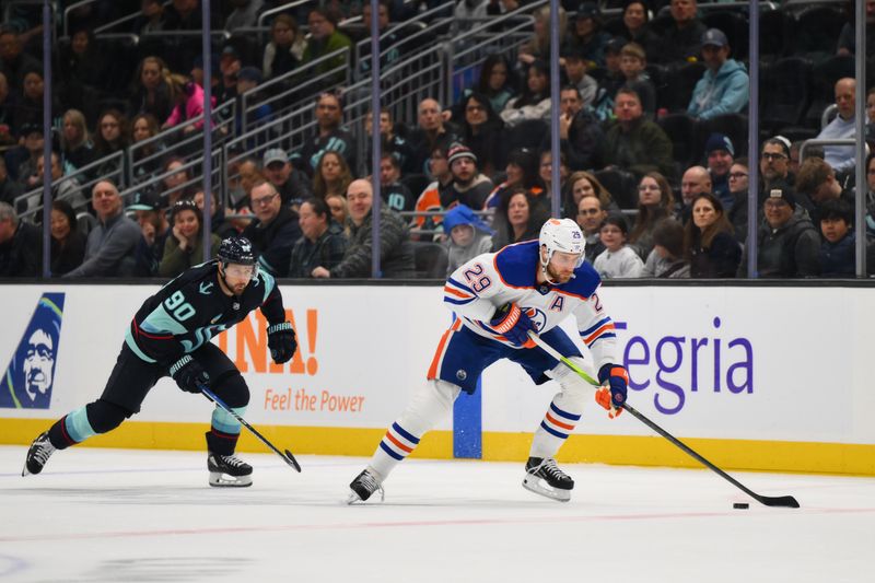 Mar 2, 2024; Seattle, Washington, USA; Edmonton Oilers center Leon Draisaitl (29) advances the puck while chased by Seattle Kraken left wing Tomas Tatar (90) during the first period at Climate Pledge Arena. Mandatory Credit: Steven Bisig-USA TODAY Sports