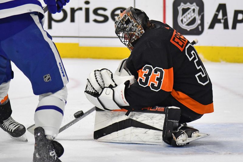 Mar 19, 2024; Philadelphia, Pennsylvania, USA; Philadelphia Flyers goaltender Samuel Ersson (33) covers the puck against the Toronto Maple Leafs during the second period at Wells Fargo Center. Mandatory Credit: Eric Hartline-USA TODAY Sports