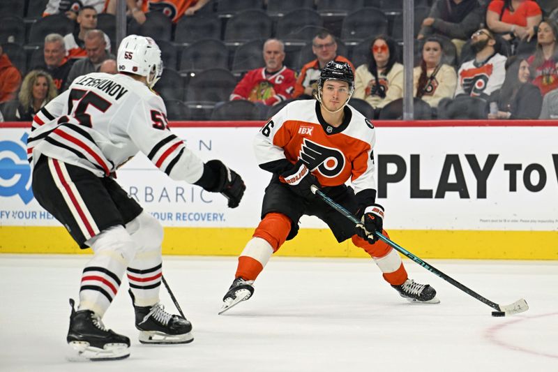 Mar 26, 2026; Philadelphia, Pennsylvania, USA; Philadelphia Flyers center Trevor Zegras (46) is defended by Chicago Blackhawks defenseman Artyom Levshunov (55) during the third period at Xfinity Mobile Arena. Mandatory Credit: Eric Hartline-Imagn Images