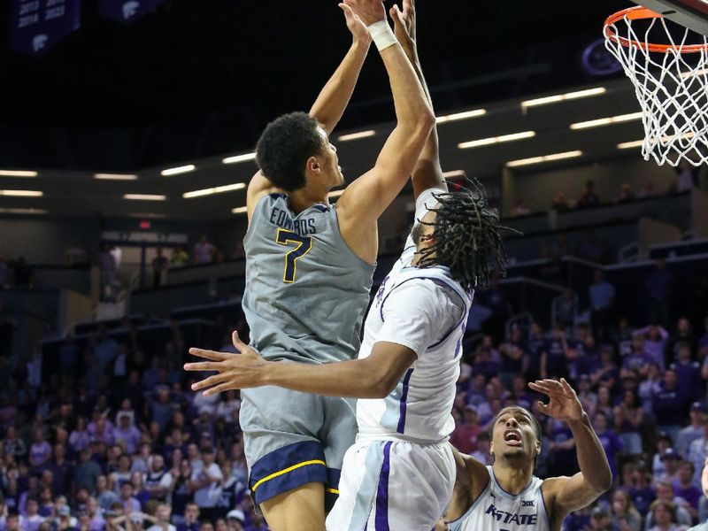 Feb 26, 2024; Manhattan, Kansas, USA; West Virginia Mountaineers center Jesse Edwards (7) shoots against Kansas State Wildcats center Will McNair Jr. (13) in overtime at Bramlage Coliseum. Mandatory Credit: Scott Sewell-USA TODAY Sports