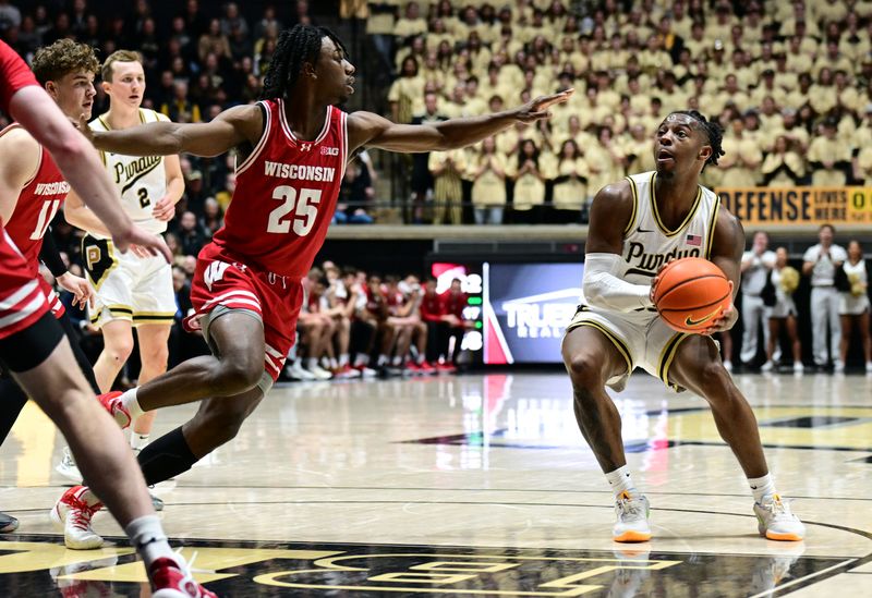 Mar 10, 2024; West Lafayette, Indiana, USA; Wisconsin Badgers guard John Blackwell (25) reacts to Purdue Boilermakers guard Lance Jones (55) preparing to shoot the ball during the second half at Mackey Arena. Mandatory Credit: Marc Lebryk-USA TODAY Sports