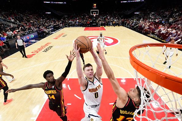 ATLANTA, GA - DECEMBER 11: Christian Braun #0 of the Denver Nuggets drives to the basket during the game against the Atlanta Hawks on December 11, 2023 at State Farm Arena in Atlanta, Georgia.  NOTE TO USER: User expressly acknowledges and agrees that, by downloading and/or using this Photograph, user is consenting to the terms and conditions of the Getty Images License Agreement. Mandatory Copyright Notice: Copyright 2023 NBAE (Photo by Adam Hagy/NBAE via Getty Images)