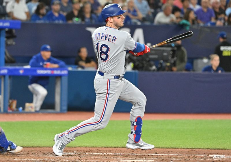 Sep 12, 2023; Toronto, Ontario, CAN;  Texas Rangers designated hitter Mitch Garver (18) hits a single against the Toronto Blue Jays in the sixth inning at Rogers Centre. Mandatory Credit: Dan Hamilton-USA TODAY Sports