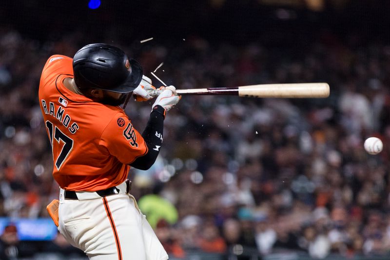 Aug 30, 2024; San Francisco, California, USA; San Francisco Giants left fielder Heliot Ramos (17) breaks his bat while hitting a single against the Miami Marlins during the sixth inning at Oracle Park. Mandatory Credit: John Hefti-USA TODAY Sports