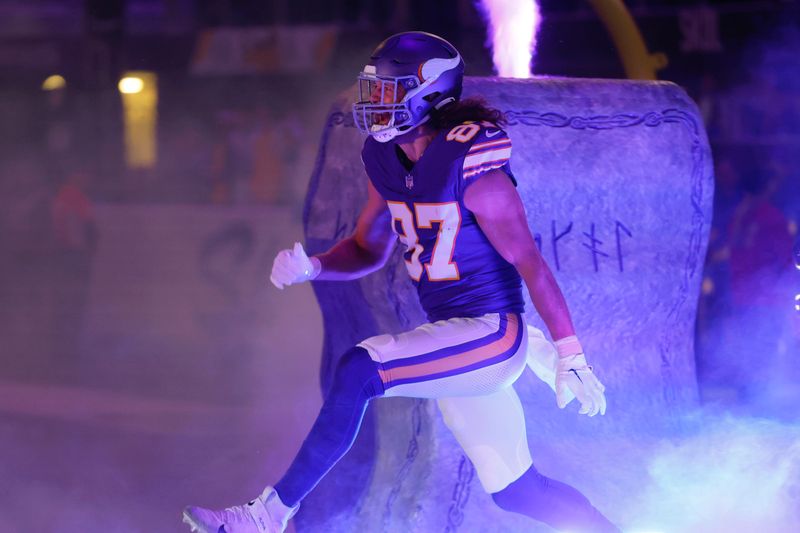 Minnesota Vikings tight end T.J. Hockenson (87) runs onto the field before an NFL football game against the Chicago Bears, Monday, Nov. 27, 2023, in Minneapolis. (AP Photo/Bruce Kluckhohn)