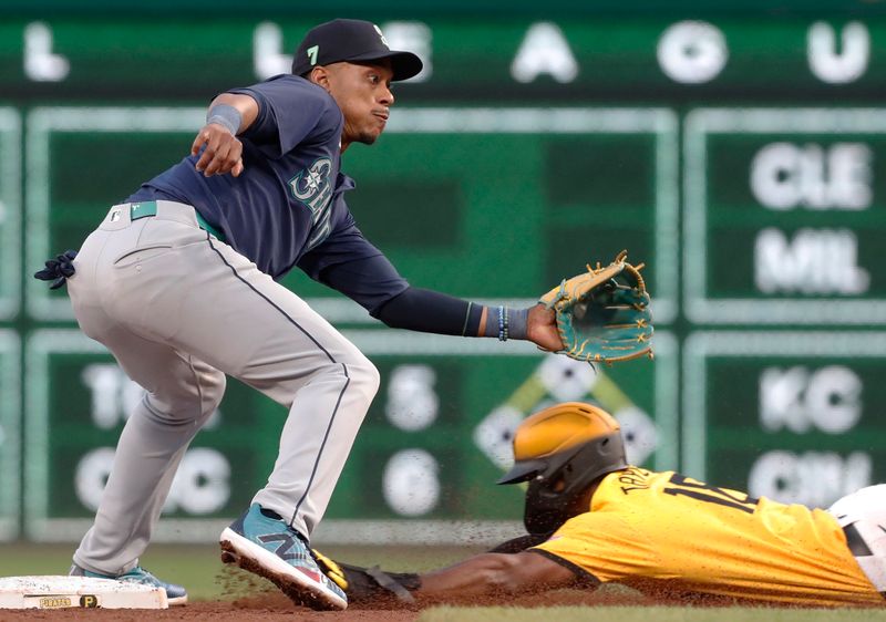 Aug 16, 2024; Pittsburgh, Pennsylvania, USA;  Pittsburgh Pirates center fielder Michael A. Taylor (18) steals second base against Seattle Mariners second baseman Jorge Polanco (7) during the fifth inning at PNC Park. Mandatory Credit: Charles LeClaire-USA TODAY Sports