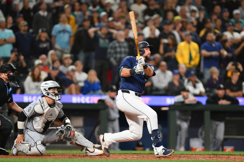 Jun 10, 2024; Seattle, Washington, USA; Seattle Mariners catcher Cal Raleigh (29) hits a walk-off grand slam against the Chicago White Sox during the ninth inning at T-Mobile Park. Mandatory Credit: Steven Bisig-USA TODAY Sports