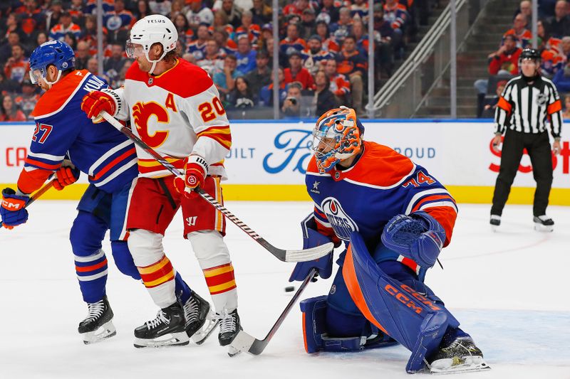 Oct 13, 2024; Edmonton, Alberta, CAN; Calgary Flames forward Blake Coleman (20) deflects a shot wide of Edmonton Oilers goaltender Stuart Skinner (74) during the second period at Rogers Place. Mandatory Credit: Perry Nelson-Imagn Images