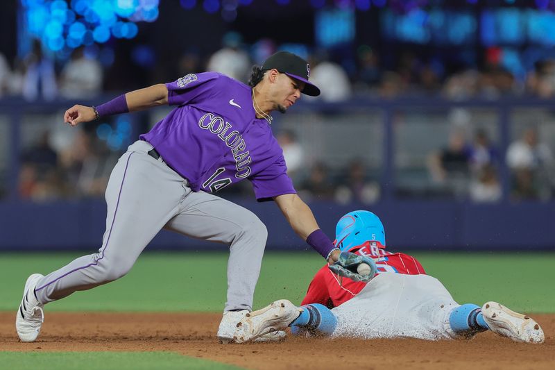 Jul 22, 2023; Miami, Florida, USA; Miami Marlins left fielder Jon Berti (5) steals second base against Colorado Rockies shortstop Ezequiel Tovar (14) during the seventh inning at loanDepot Park. Mandatory Credit: Sam Navarro-USA TODAY Sports