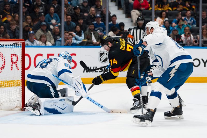 Mar 19, 2026; Vancouver, British Columbia, CAN; Tampa Bay Lightning goalie Andrei Vasilevskiy (88) makes a save on Vancouver Canucks forward Jake DeBrusk (74) in the second period at Rogers Arena. Mandatory Credit: Bob Frid-Imagn Images