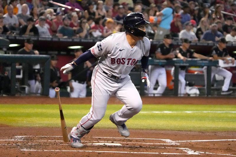 May 28, 2023; Phoenix, Arizona, USA; Boston Red Sox left fielder Masataka Yoshida (7) hits a single against the against the Arizona Diamondbacks in the first inning at Chase Field. Mandatory Credit: Rick Scuteri-USA TODAY Sports