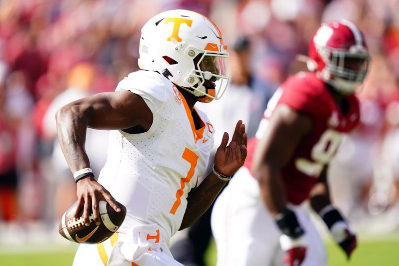 Oct 21, 2023; Tuscaloosa, Alabama, USA; Tennessee Volunteers quarterback Joe Milton III (7) scrambles up the field against the Alabama Crimson Tide during the first half at Bryant-Denny Stadium. Mandatory Credit: John David Mercer-USA TODAY Sports