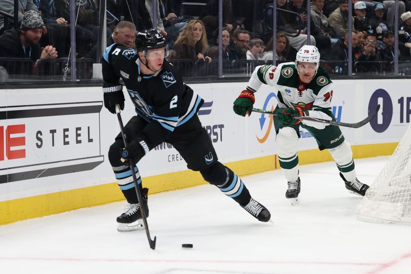 Feb 27, 2026; Salt Lake City, Utah, USA; Utah Mammoth defenseman Olli Maatta (2) skates with the puck against Minnesota Wild center Nico Sturm (78) during the first period at Delta Center. Mandatory Credit: Rob Gray-Imagn Images