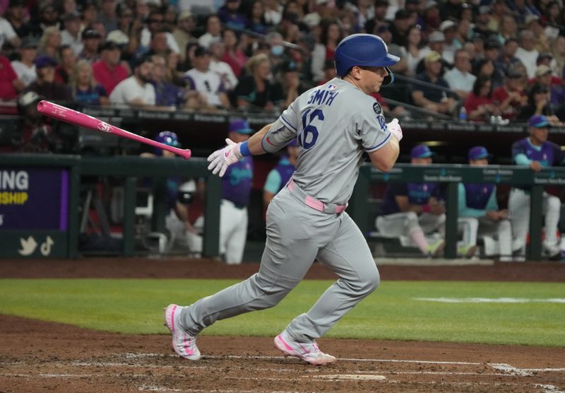 May 11, 2025; Phoenix, Arizona, USA; Los Angeles Dodgers catcher Will Smith (16) hits an RBI single against the Arizona Diamondbacks in the fifth inning at Chase Field. Mandatory Credit: Rick Scuteri-Imagn Images