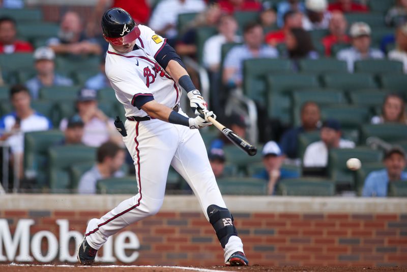 May 8, 2025; Atlanta, Georgia, USA; Atlanta Braves third baseman Austin Riley (27) hits a double against the Cincinnati Reds in the first inning at Truist Park. Mandatory Credit: Brett Davis-Imagn Images
