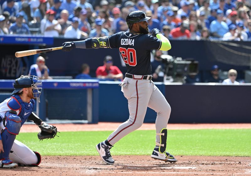 May 13, 2023; Toronto, Ontario, CAN; Atlanta Braves designated hitter Marcell Ozuna (20) hits a single against the Toronto Blue Jays in the fourth inning at Rogers Centre. Mandatory Credit: Dan Hamilton-USA TODAY Sports