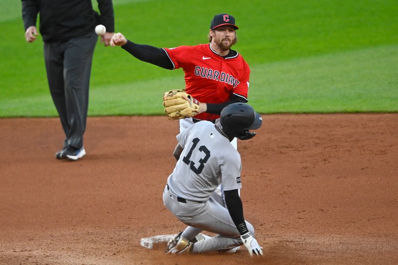 Apr 22, 2025; Cleveland, Ohio, USA; Cleveland Guardians second baseman Daniel Schneemann (10) turns a double play beside New York Yankees second baseman Jazz Chisholm Jr. (13) in the fourth inning at Progressive Field. Mandatory Credit: David Richard-Imagn Images