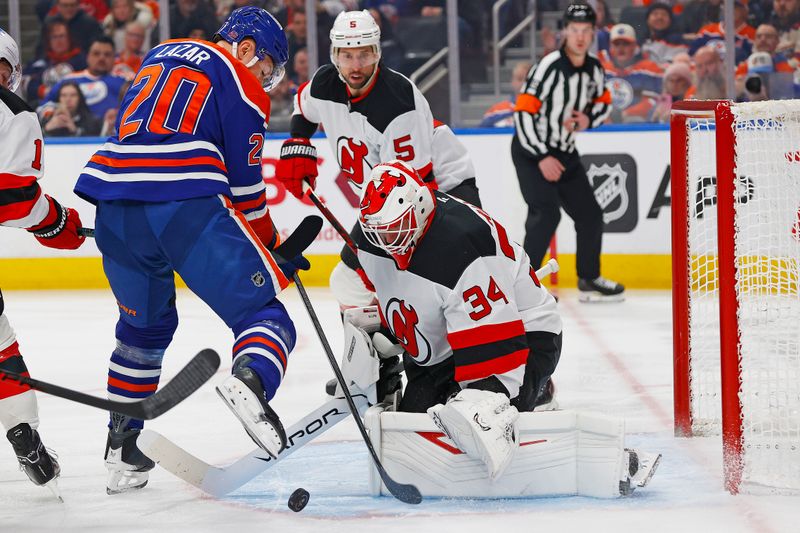 Jan 20, 2026; Edmonton, Alberta, CAN; New Jersey Devils goaltender Jake Allen (34) makes a save on Edmonton Oilers forward Curtis Lazar (20) during the first period at Rogers Place. Mandatory Credit: Perry Nelson-Imagn Images