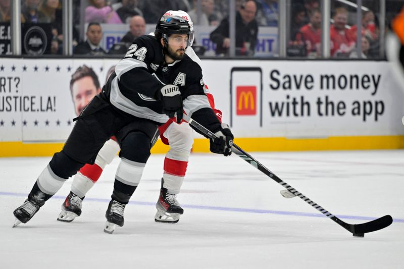 Nov 16, 2024; Los Angeles, California, USA; Los Angeles Kings center Phillip Danault (24) controls the puck away from Detroit Red Wings center Marco Kasper (92) in the second period at Crypto.com Arena. Mandatory Credit: Jayne Kamin-Oncea-Imagn Images