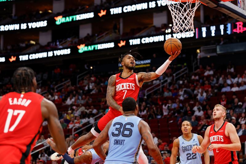 HOUSTON, TEXAS - OCTOBER 25: Cam Whitmore #7 of the Houston Rockets goes up for a shot while defended by Ja Morant #12 of the Memphis Grizzlies in the first half at Toyota Center on October 25, 2024 in Houston, Texas.  NOTE TO USER: User expressly acknowledges and agrees that, by downloading and or using this photograph, User is consenting to the terms and conditions of the Getty Images License Agreement.  (Photo by Tim Warner/Getty Images)