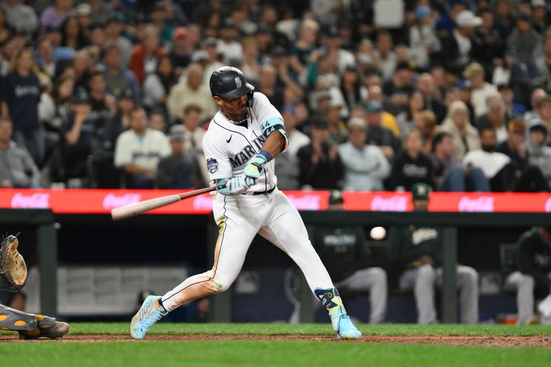 Aug 28, 2023; Seattle, Washington, USA; Seattle Mariners center fielder Julio Rodriguez (44) hits a single against the Oakland Athletics during the eighth inning at T-Mobile Park. Mandatory Credit: Steven Bisig-USA TODAY Sports