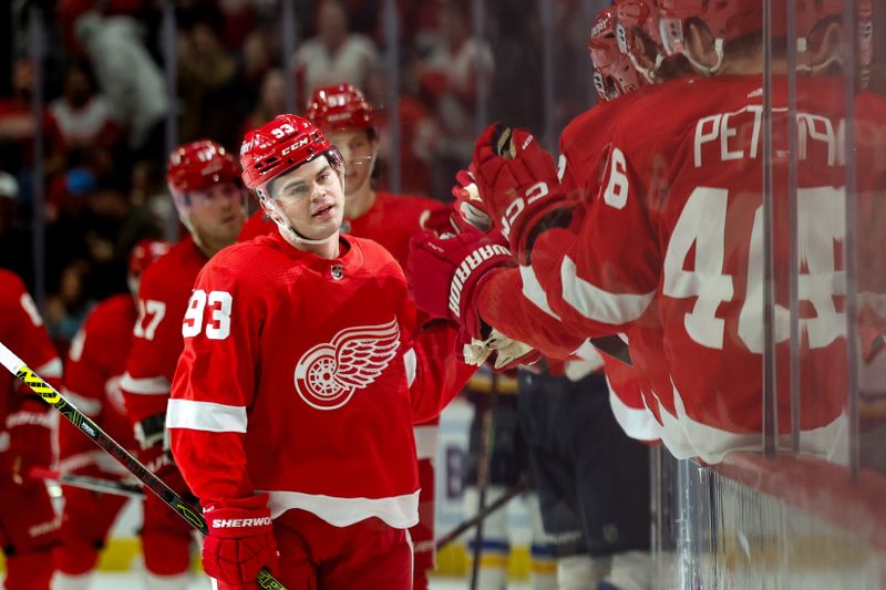 Feb 24, 2024; Detroit, Michigan, USA;  Detroit Red Wings right wing Alex DeBrincat (93) receives congratulations from teammates after scoring in the first period against the St. Louis Blues at Little Caesars Arena. Mandatory Credit: Rick Osentoski-USA TODAY Sports