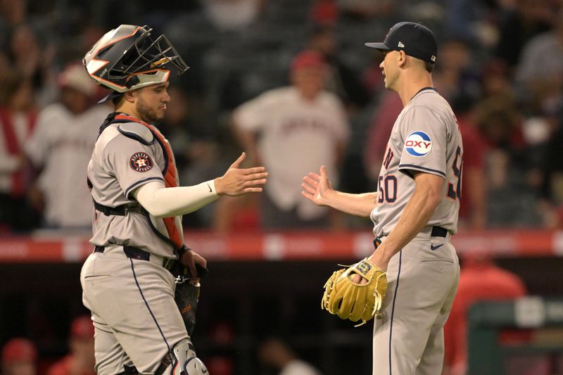 Jun 8, 2024; Anaheim, California, USA;  Houston Astros catcher Yainer Diaz (21) shakes hands with relief pitcher Tayler Scott (50) after the final out of the ninth inning against the Los Angeles Angels at Angel Stadium. Mandatory Credit: Jayne Kamin-Oncea-USA TODAY Sports