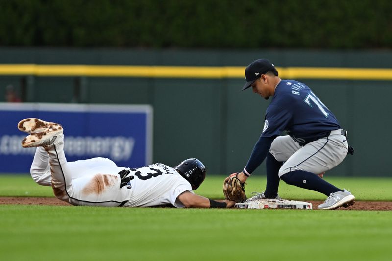 Aug 13, 2024; Detroit, Michigan, USA;  Detroit Tigers third baseman Gio Urshela (13) slides safely back into second base ahead of a pick off throw to Seattle Mariners shortstop Leo Rivas (76) in the third inning at Comerica Park. Mandatory Credit: Lon Horwedel-USA TODAY Sports