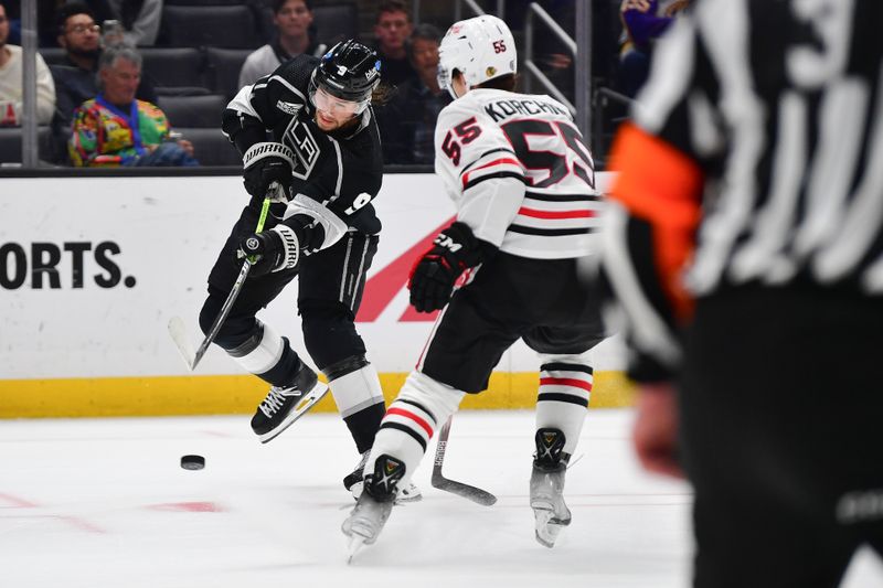 Apr 18, 2024; Los Angeles, California, USA; Los Angeles Kings right wing Adrian Kempe (9) scores a goal against the defense of Chicago Blackhawks defenseman Kevin Korchinski (55) during the overtime period at Crypto.com Arena. Mandatory Credit: Gary A. Vasquez-USA TODAY Sports