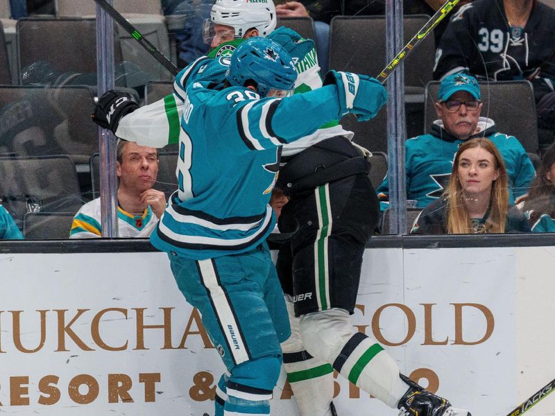 Jan 18, 2023; San Jose, California, USA; San Jose Sharks defenseman Mario Ferraro (38) and Dallas Stars right wing Denis Gurianov (34) battle on the boards during the first period at SAP Center at San Jose. Mandatory Credit: Neville E. Guard-USA TODAY Sports