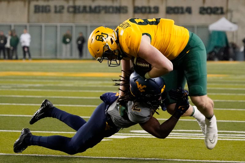 Nov 25, 2023; Waco, Texas, USA; Baylor Bears tight end Matthew Klopfenstein (85) is tackled by West Virginia Mountaineers safety Aubrey Burks (2) during the second half at McLane Stadium. Mandatory Credit: Raymond Carlin III-USA TODAY Sports