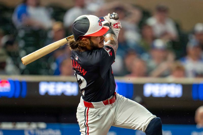 Aug 26, 2024; Minneapolis, Minnesota, USA; Minnesota Twins center fielder Austin Martin (82) hits a RBI single against the Atlanta Braves in the fifth inning at Target Field. Mandatory Credit: Jesse Johnson-USA TODAY Sports